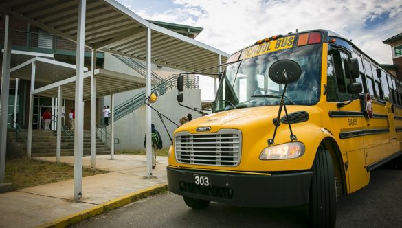 A school bus parked outside of school.