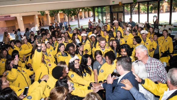 City Year AmeriCorps members on their graduation day bring it in for a huddle to perform a Spirit Break.